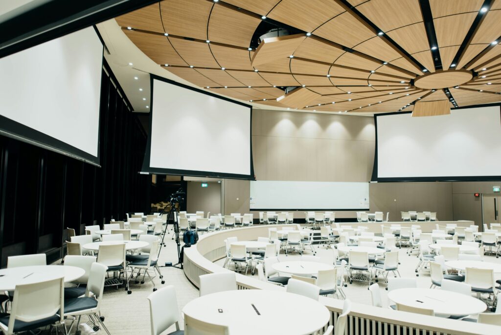 Big conference room with projection screens.