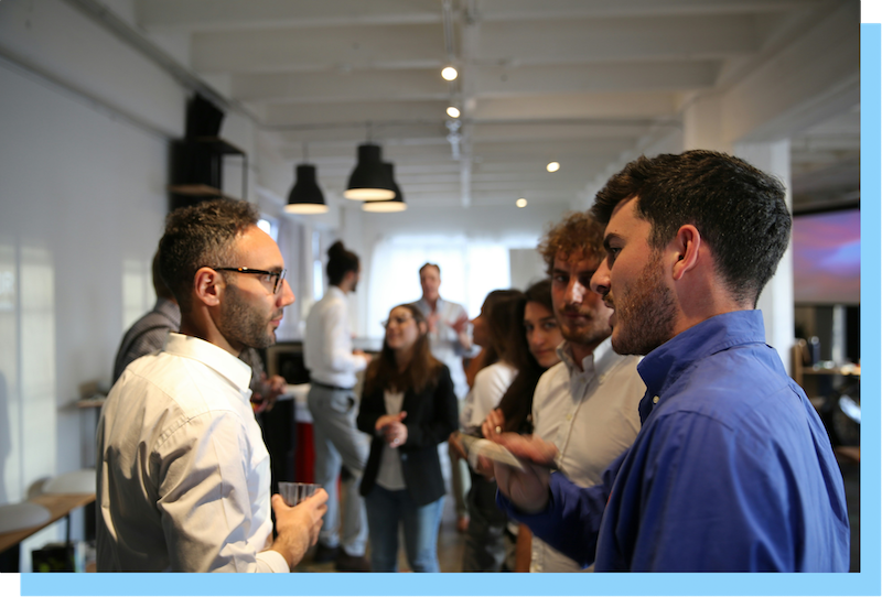 Group of people networking with drinks.