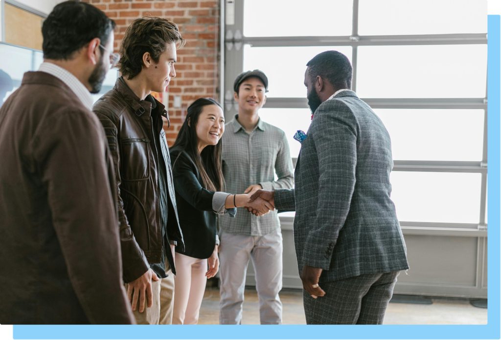 People shaking hands at a networking event.